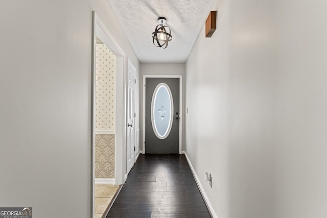 doorway to outside with baseboards and hardwood / wood-style floors