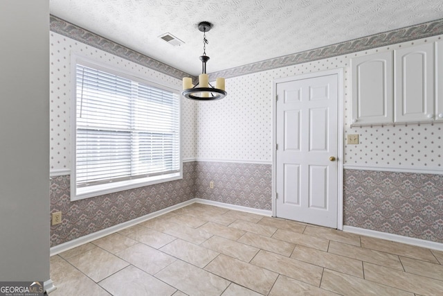 unfurnished dining area with baseboards, a wealth of natural light, and wallpapered walls
