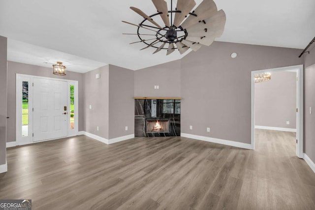 220 Makers Way, Dawsonville, GA 30534 - entrance foyer with an inviting chandelier, vaulted ceiling, wood finished floors, and baseboards