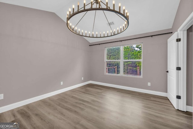 220 Makers Way, Dawsonville, GA 30534 - unfurnished dining area with vaulted ceiling, a chandelier, baseboards, and wood finished floors