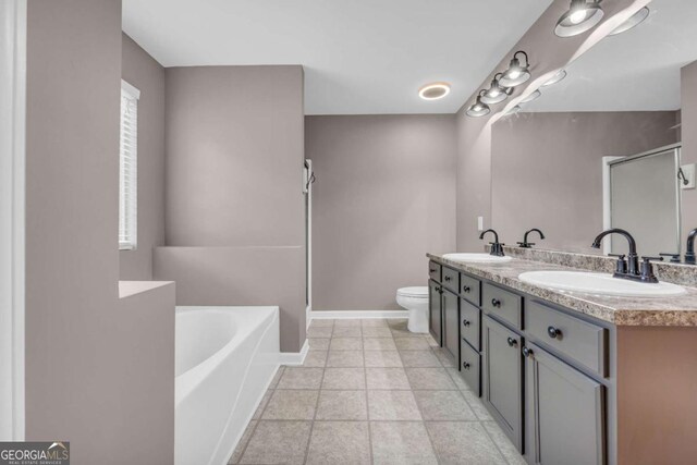 220 Makers Way, Dawsonville, GA 30534 - full bathroom with double vanity, a garden tub, a stall shower, a sink, and baseboards