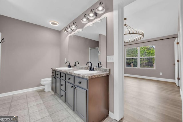 220 Makers Way, Dawsonville, GA 30534 - full bathroom featuring a notable chandelier, double vanity, baseboards, and a sink