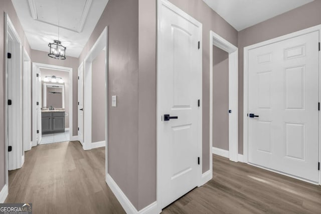 220 Makers Way, Dawsonville, GA 30534 - hallway with attic access, wood finished floors, and baseboards