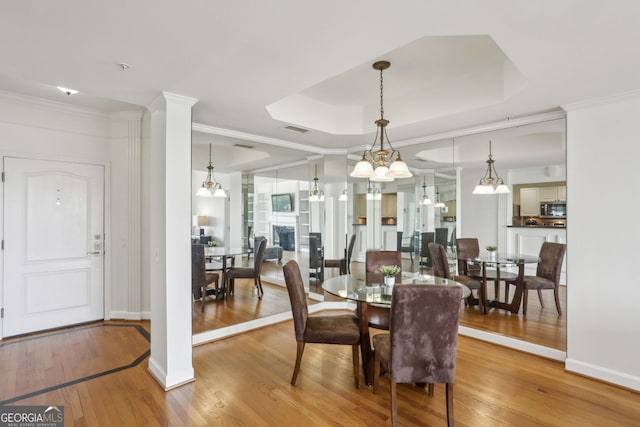 3475 Oak Valley Rd NE Unit 2060, Atlanta, GA 30326 - dining room with baseboards, crown molding, visible vents, and wood finished floors