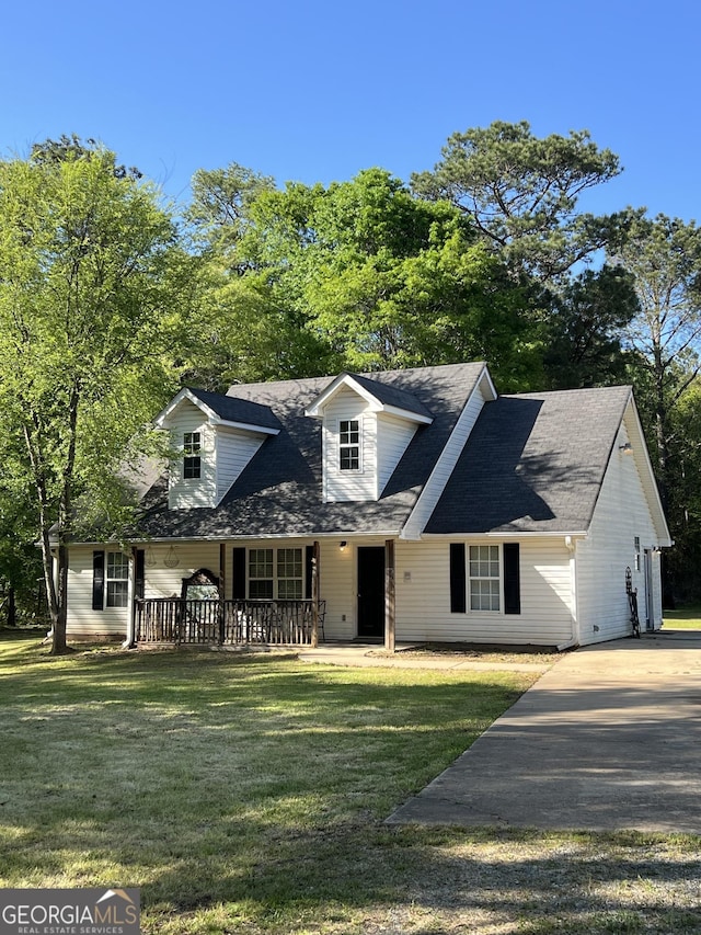 new england style home with a porch and a front lawn