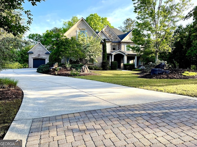 craftsman-style house featuring a front lawn, driveway, and a garage