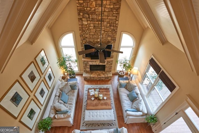 1345 Cashiers Way, Roswell, GA 30075 - living room featuring high vaulted ceiling, a stone fireplace, plenty of natural light, wood finished floors, and a ceiling fan