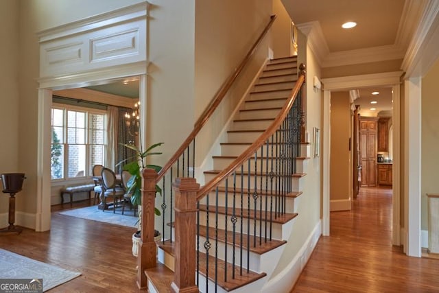 1345 Cashiers Way, Roswell, GA 30075 - stairs featuring crown molding, wood finished floors, and recessed lighting