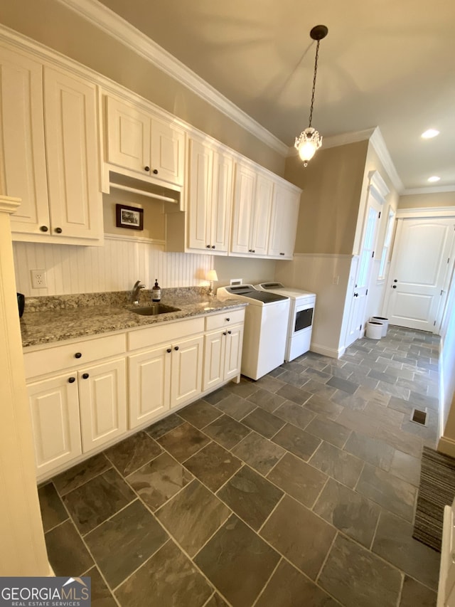 1345 Cashiers Way, Roswell, GA 30075 - kitchen featuring ornamental molding, wainscoting, white cabinetry, hanging light fixtures, and light stone countertops