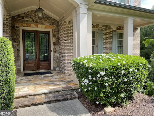 1345 Cashiers Way, Roswell, GA 30075 - view of exterior entry featuring french doors, brick siding, and a porch