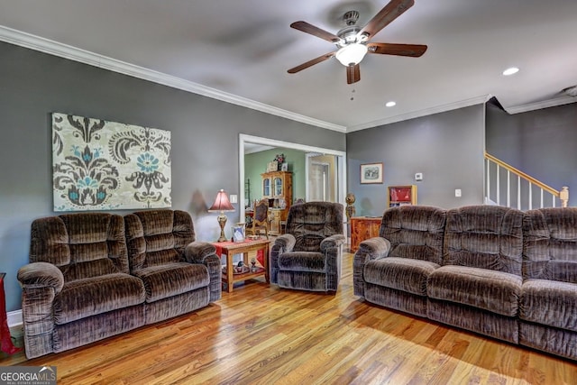 living area with ceiling fan, ornamental molding, recessed lighting, and wood finished floors