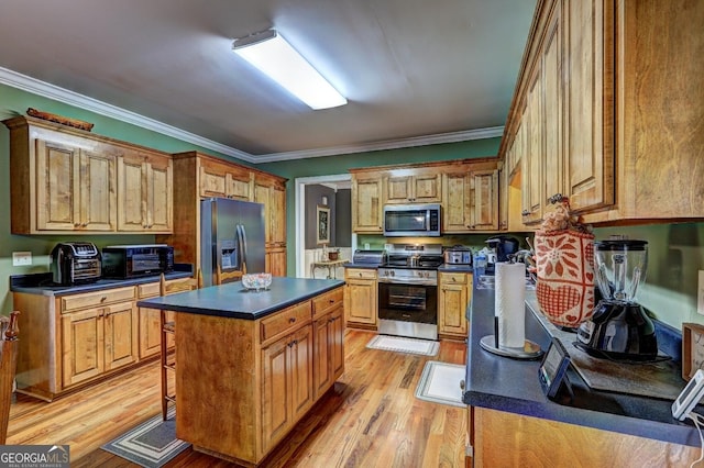 kitchen with dark countertops, stainless steel appliances, light wood-type flooring, and a kitchen island