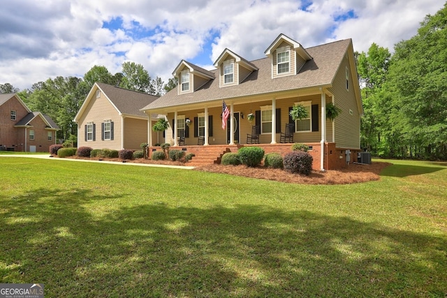 cape cod home with covered porch and a front yard