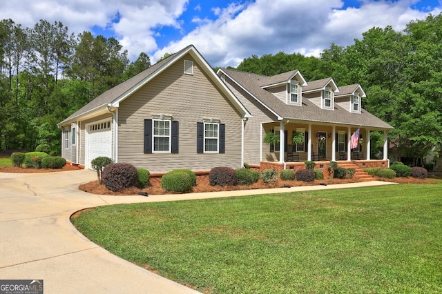 view of front of home with covered porch, driveway, an attached garage, and a front yard