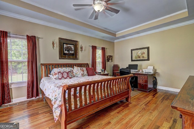 bedroom with baseboards, light wood-type flooring, and multiple windows
