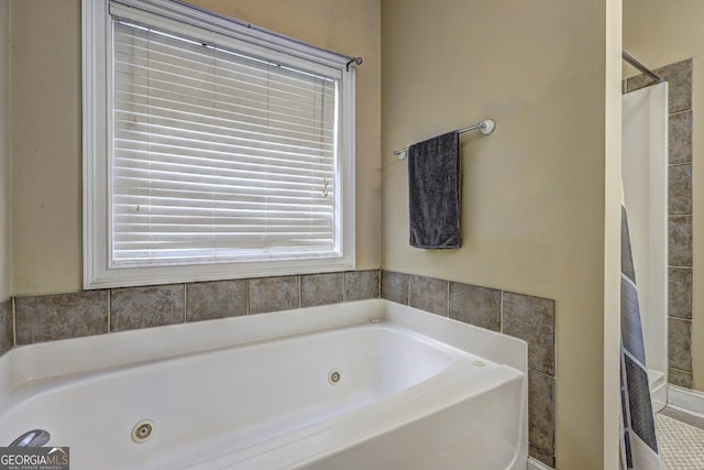bathroom with walk in shower and a jetted tub