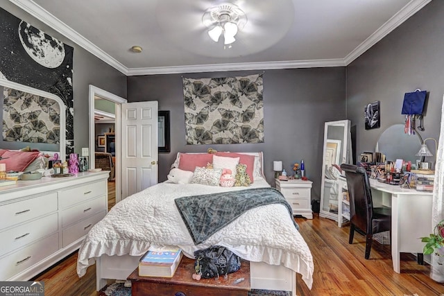 bedroom featuring a ceiling fan, ornamental molding, and wood finished floors