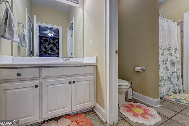 full bathroom featuring a shower with curtain, toilet, baseboards, tile patterned floors, and vanity