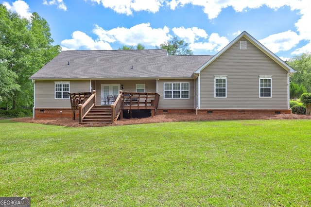 rear view of house with a lawn, a deck, and crawl space