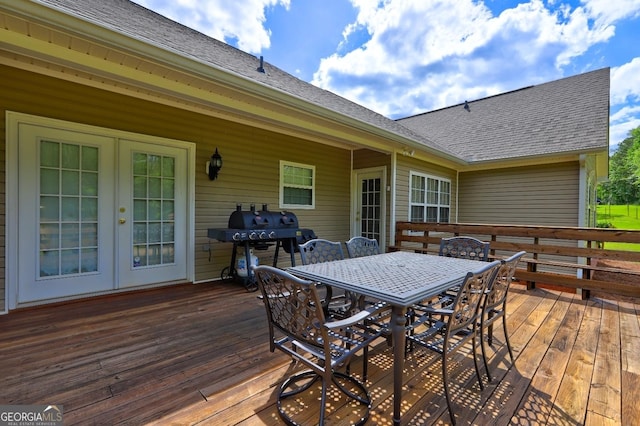 deck featuring area for grilling, outdoor dining area, and french doors