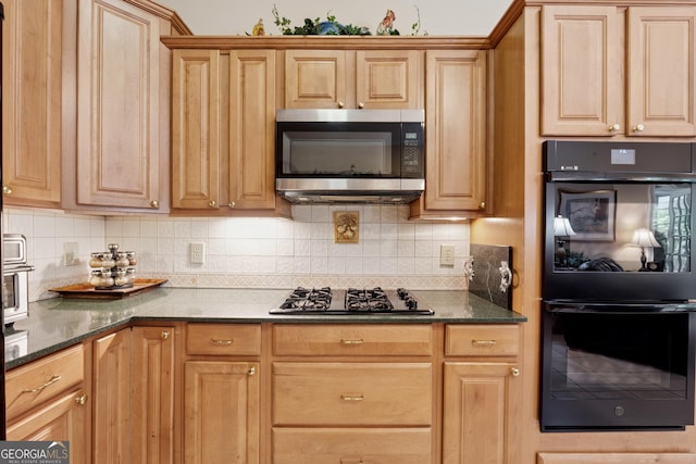 6125 Fouts Mill Rd, Douglasville, GA 30135 - kitchen featuring stainless steel microwave, gas cooktop, dobule oven black, backsplash, and dark stone counters