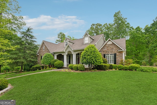 6125 Fouts Mill Rd, Douglasville, GA 30135 - view of front facade featuring covered porch, a shingled roof, a front lawn, and stone siding