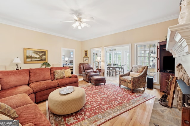 6125 Fouts Mill Rd, Douglasville, GA 30135 - living area featuring light wood-type flooring, ornamental molding, ceiling fan, and a fireplace with raised hearth