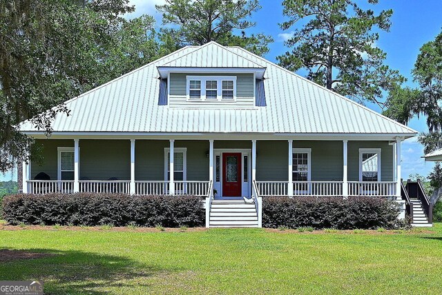 1261 Otter Slide Loop NE, Townsend, GA 31331 - country-style home with a porch, a front lawn, metal roof, and stairs