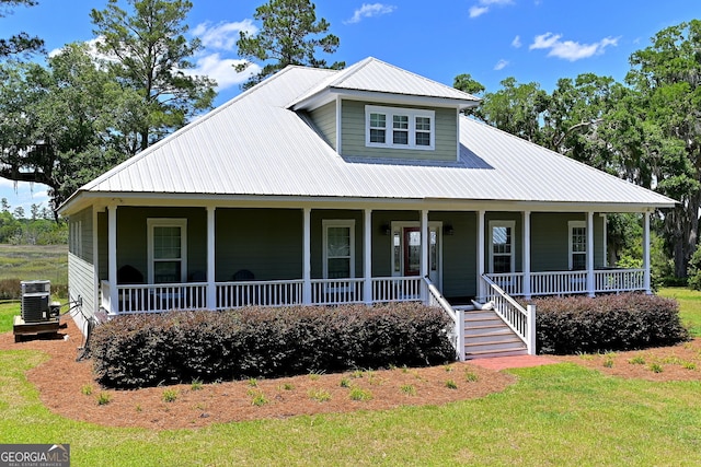 1261 Otter Slide Loop NE, Townsend, GA 31331 - view of front of home featuring a porch, metal roof, and central air condition unit