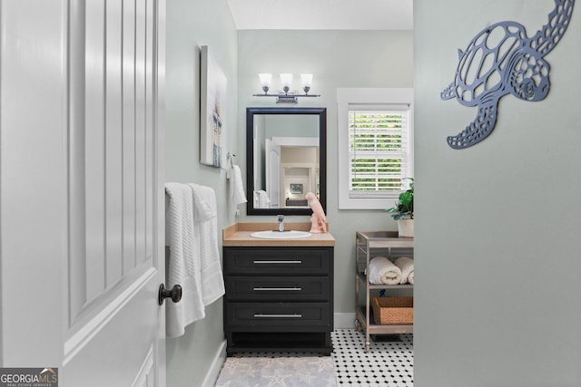 1261 Otter Slide Loop NE, Townsend, GA 31331 - bathroom with baseboards, vanity, and tile patterned floors