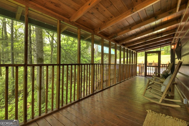 unfurnished sunroom with beam ceiling