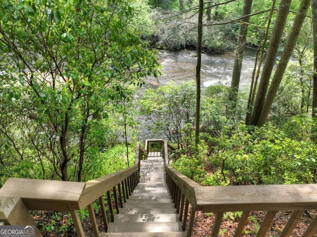view of home's community featuring a water view and a view of trees