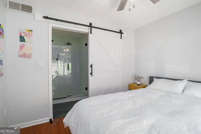 2716 Suwanee Way SE, Marietta, GA 30067 - bedroom featuring a ceiling fan, dark wood finished floors, visible vents, a barn door, and baseboards