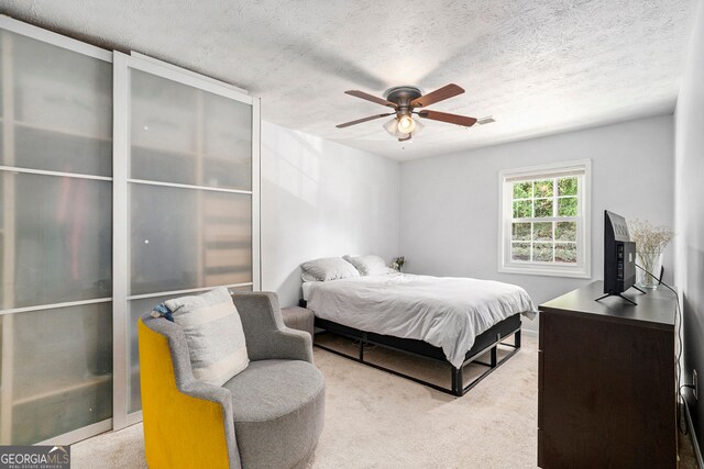 2716 Suwanee Way SE, Marietta, GA 30067 - carpeted bedroom with a textured ceiling, a ceiling fan, and visible vents