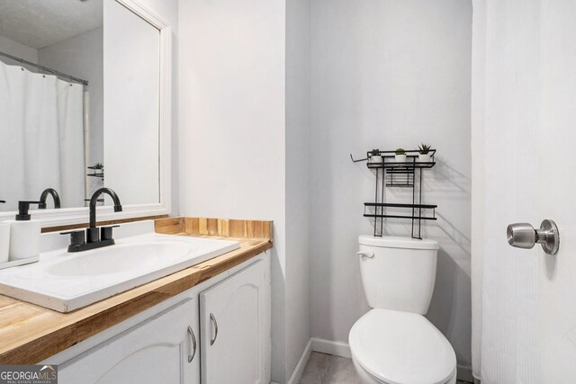 2716 Suwanee Way SE, Marietta, GA 30067 - bathroom featuring vanity, toilet, and baseboards