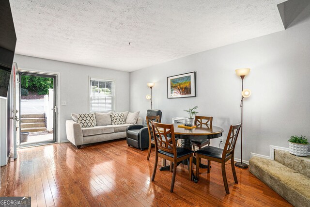 2716 Suwanee Way SE, Marietta, GA 30067 - dining space with a textured ceiling, baseboards, hardwood / wood-style floors, and stairs