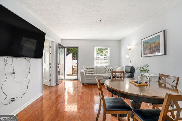 2716 Suwanee Way SE, Marietta, GA 30067 - dining space with a textured ceiling, baseboards, and hardwood / wood-style floors