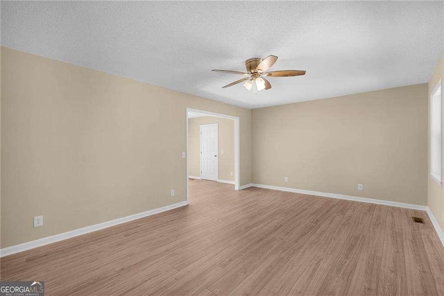 196 Highland Dr, Calhoun, GA 30701 - spare room featuring light wood-type flooring, visible vents, ceiling fan, and a textured ceiling