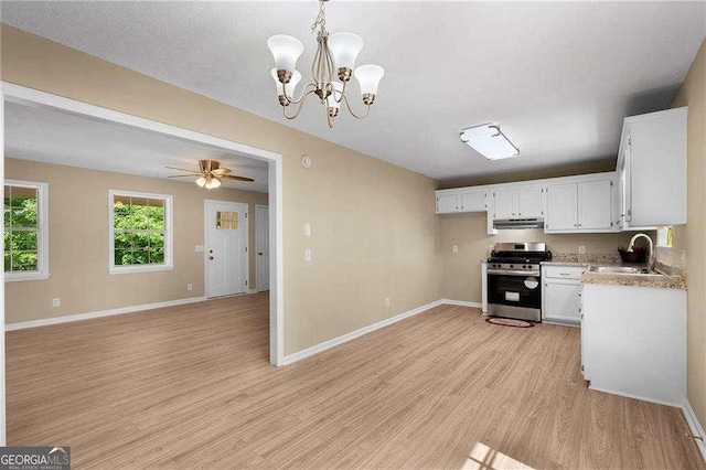 196 Highland Dr, Calhoun, GA 30701 - kitchen with a sink, stainless steel range with gas stovetop, under cabinet range hood, light wood-style flooring, and baseboards