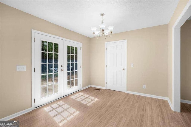 196 Highland Dr, Calhoun, GA 30701 - unfurnished dining area with baseboards, french doors, and light wood-type flooring