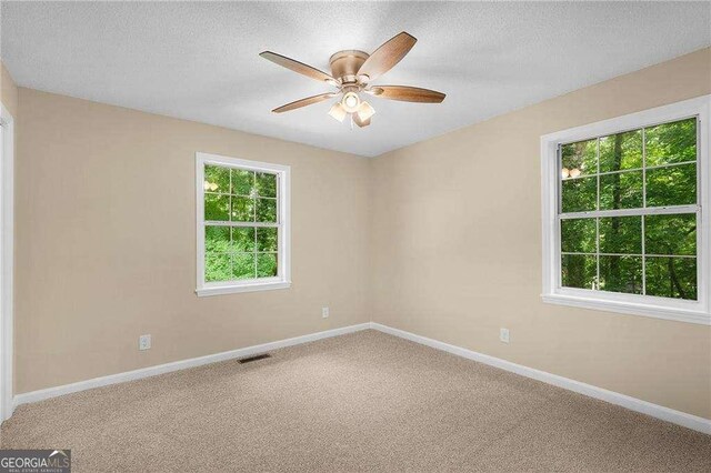 196 Highland Dr, Calhoun, GA 30701 - empty room featuring carpet flooring, a textured ceiling, visible vents, baseboards, and ceiling fan