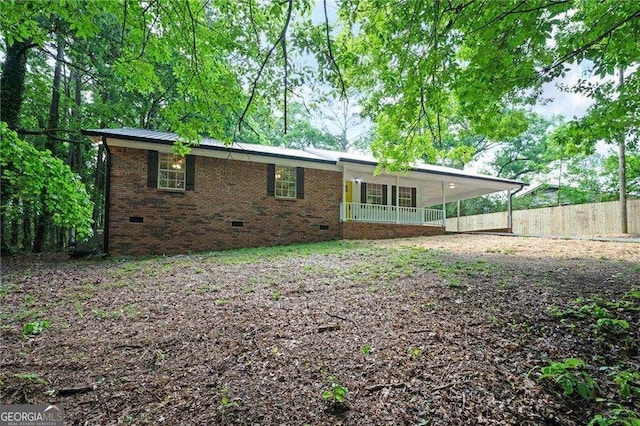 196 Highland Dr, Calhoun, GA 30701 - back of property with fence, an attached carport, brick siding, and crawl space