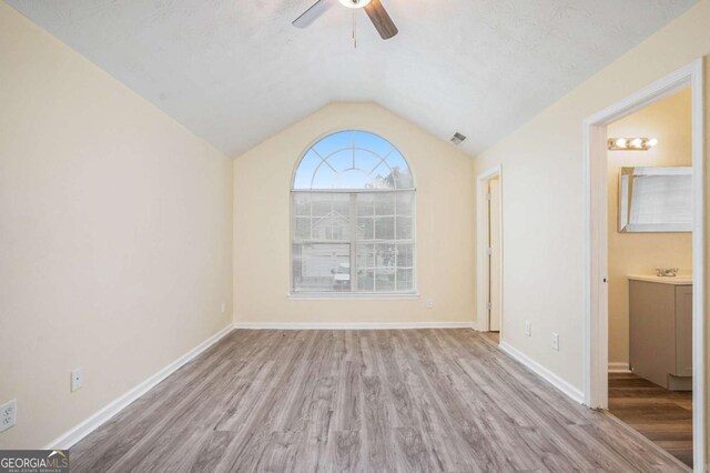 2722 S Hills, Riverdale, GA 30296 - interior space featuring wood finished floors, a ceiling fan, visible vents, baseboards, and lofted ceiling