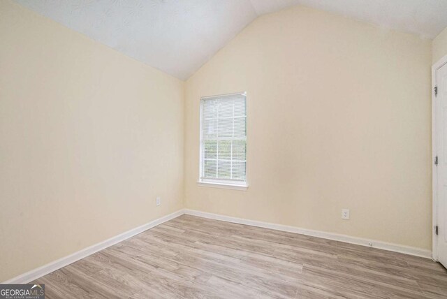2722 S Hills, Riverdale, GA 30296 - unfurnished room featuring vaulted ceiling, baseboards, and wood finished floors