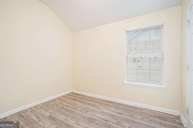 2722 S Hills, Riverdale, GA 30296 - empty room with baseboards, light wood finished floors, and vaulted ceiling