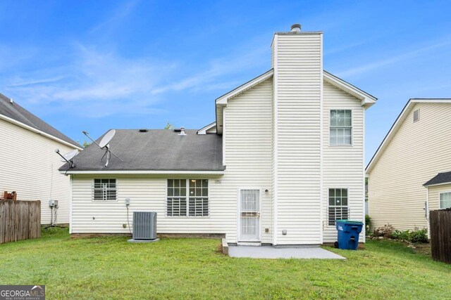 2722 S Hills, Riverdale, GA 30296 - back of house with central AC unit, fence, a chimney, and a lawn