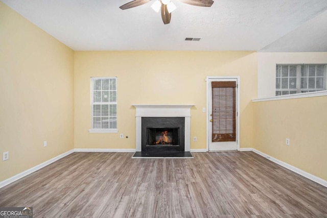 2722 S Hills, Riverdale, GA 30296 - unfurnished living room featuring wood finished floors, visible vents, ceiling fan, a lit fireplace, and baseboards