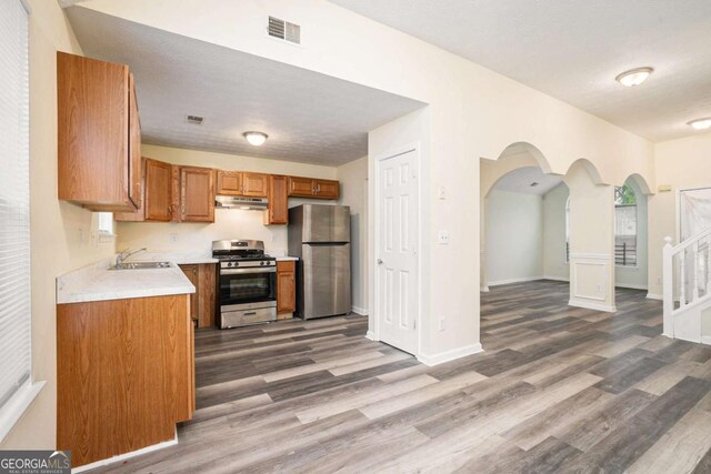 2722 S Hills, Riverdale, GA 30296 - kitchen with a sink, wood finished floors, visible vents, under cabinet range hood, and appliances with stainless steel finishes