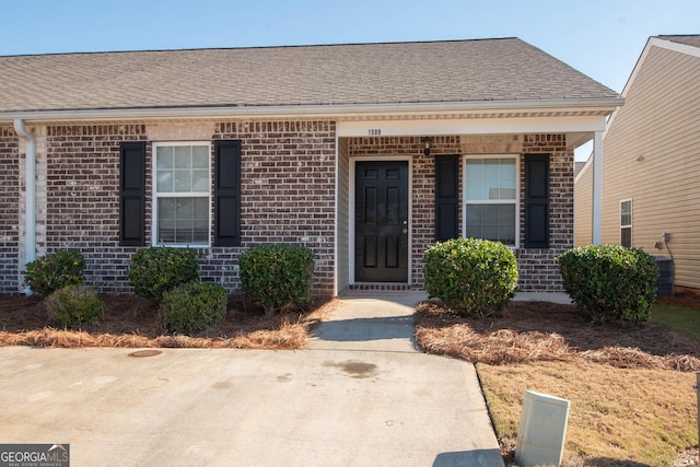 1509 Buffington Way, Griffin, GA 30224 - view of exterior entry featuring a shingled roof, brick siding, and covered porch