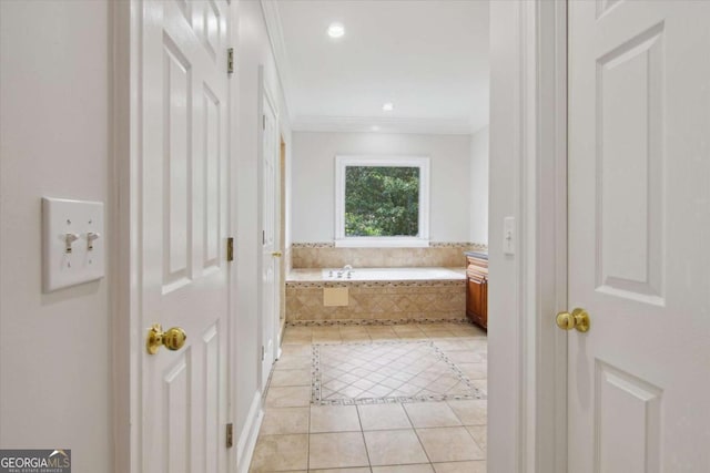 bathroom with recessed lighting, tile patterned floors, ornamental molding, and a garden tub